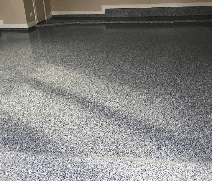7 Epoxy flooring installation by Ascent Epoxy Jacksonville in a stylish garage, highlighting durability and low maintenance.